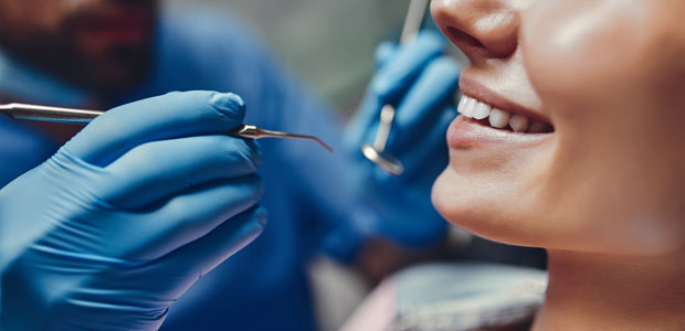 Dentist inspecting patient's teeth