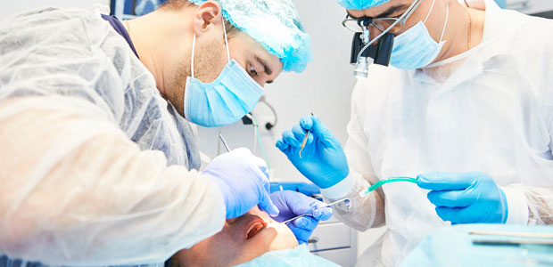 Doctors performing implant procedure